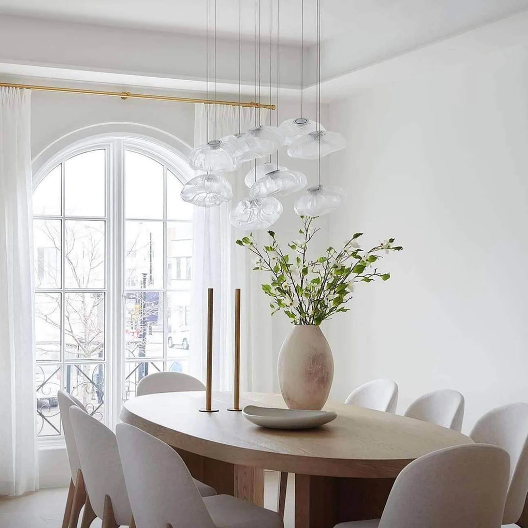 Clear_Halo_Glass_Pendant_Lights_in_Dining_Room_With_Arched_Windows_Woorglamp