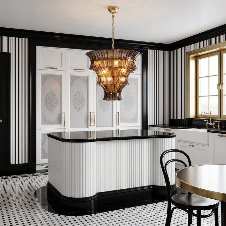 Amber glass chandelier in a black and white kitchen with checkered floor tile