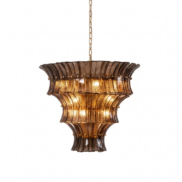 Amber tiered glass chandelier lit and shown on a white background