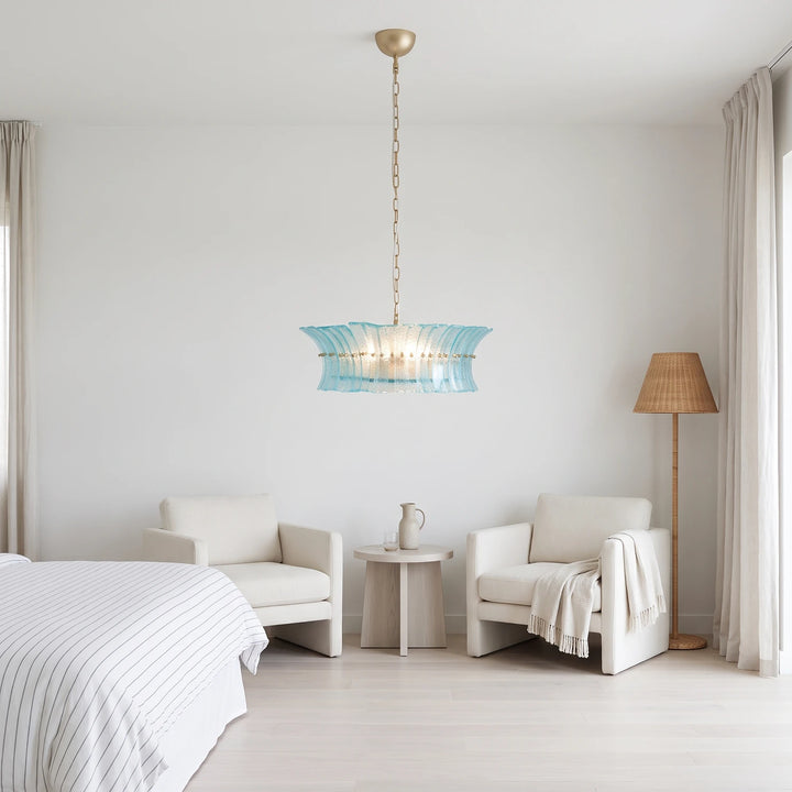 Aqua fluted chandelier in a pared-back white bedroom with a linen bed