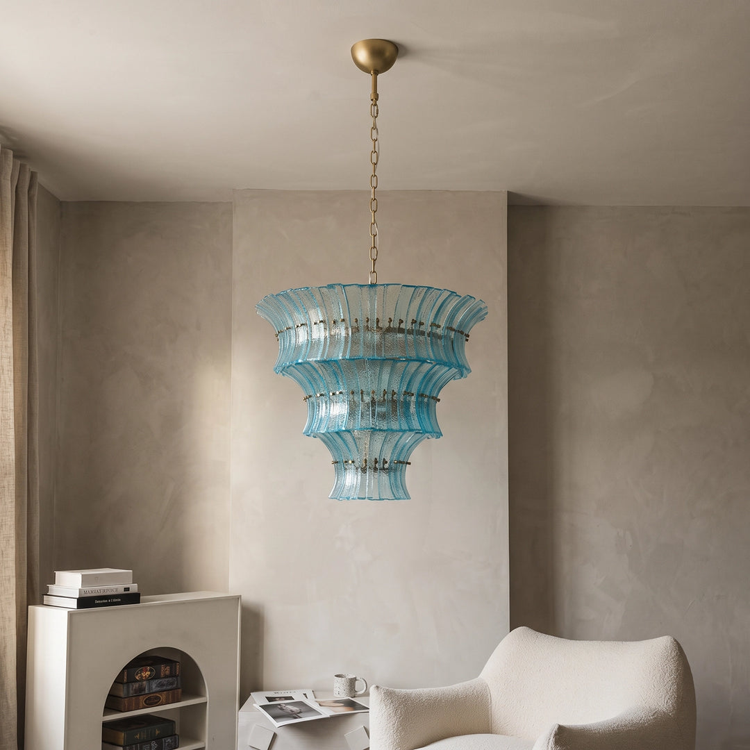 Tiered aqua fluted chandelier showing its stepped profile in a neutral room