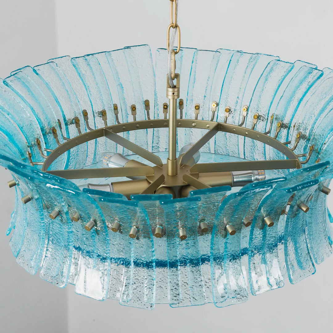 Top-down detail of the aqua fluted glass panels seated on the brass ring