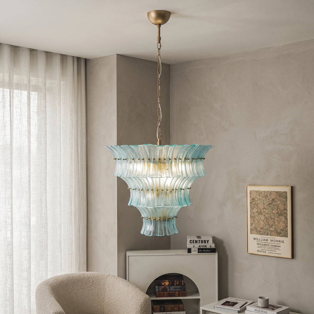Aqua glass chandelier beside sheer linen curtains in a calm living room