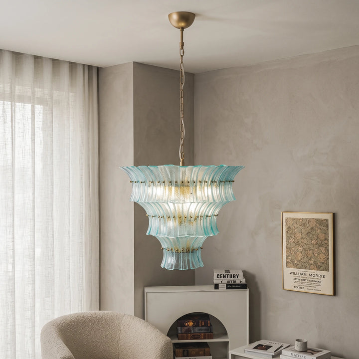 Aqua glass chandelier beside sheer linen curtains in a calm living room