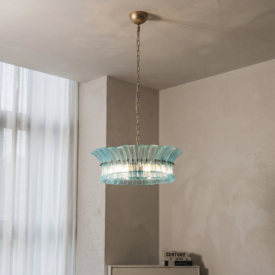 Aqua glass drum chandelier seen from below in a neutral toned interior