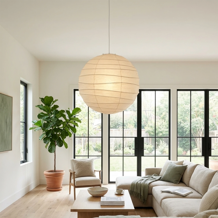 Paper pendant in a modern lounge with black-framed windows and indoor trees