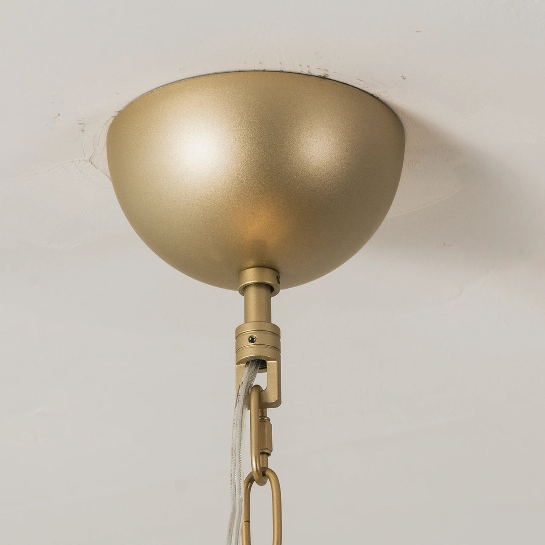 Brass ceiling canopy and chain mounted flush against a white ceiling