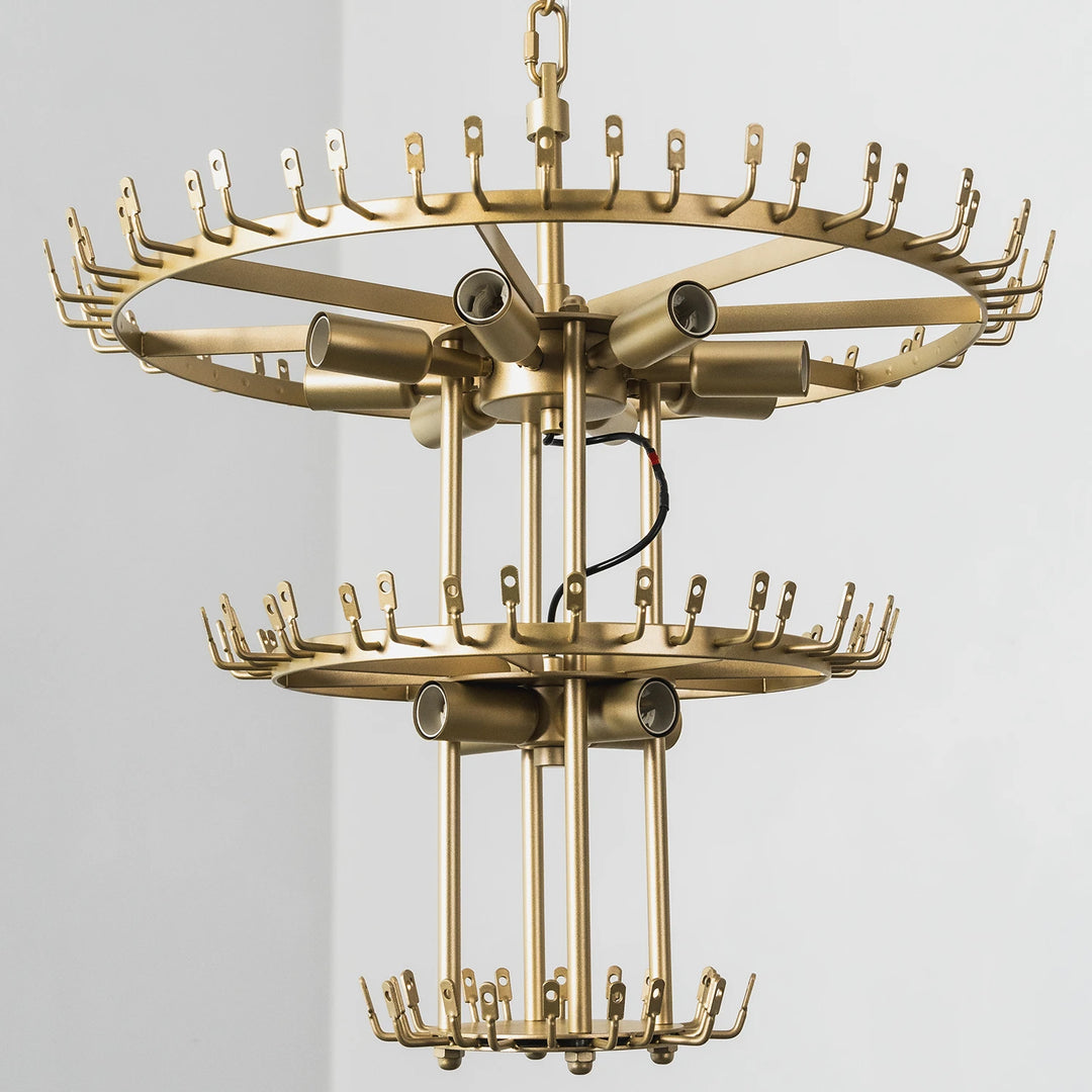Bare brass chandelier frame showing the two-tier ring structure before glass