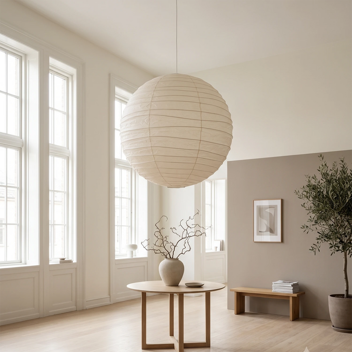Paper pendant in a bright airy room with minimal styling and a single vase