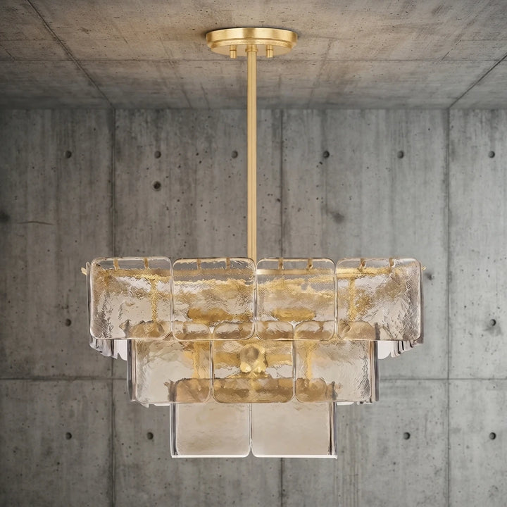 Champagne glass chandelier hanging against a smooth concrete wall