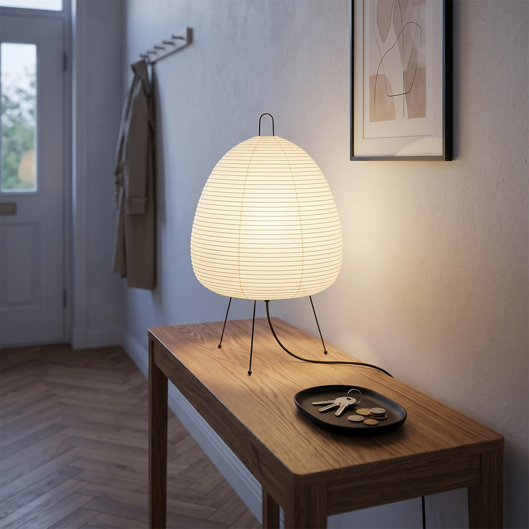 Egg-shaped paper lamp on a wooden bench in a bright hallway with herringbone floor