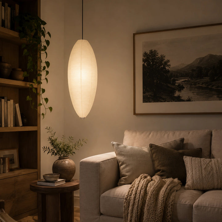 Oval paper pendant in an evening living room beside framed landscape art