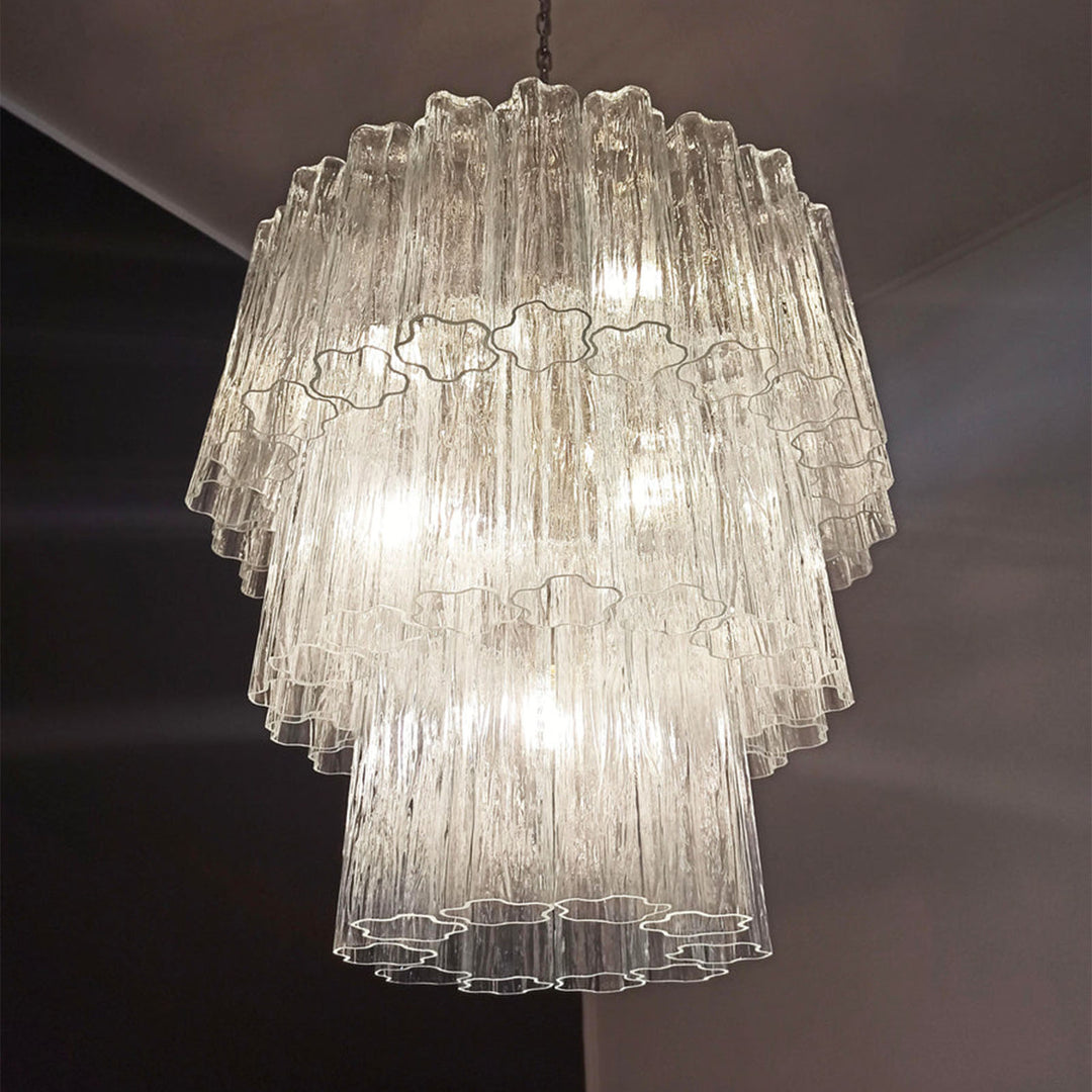 Lit Fantastic Murano Tubes Chandelier with amber glass in a dark corner view