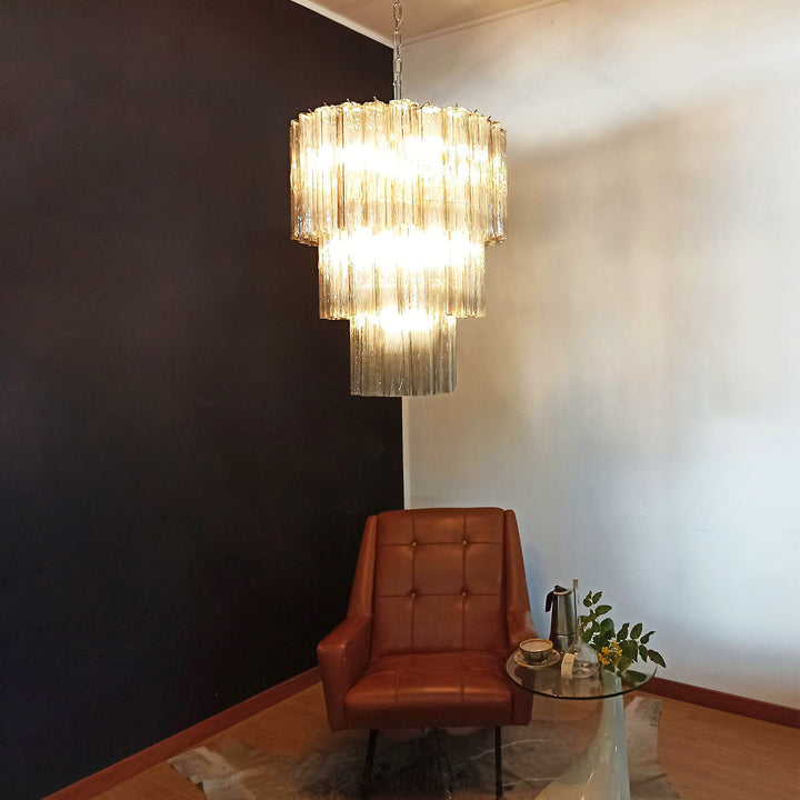 Fantastic Murano Tubes Chandelier with clear glass in a dark corner with a leather chair