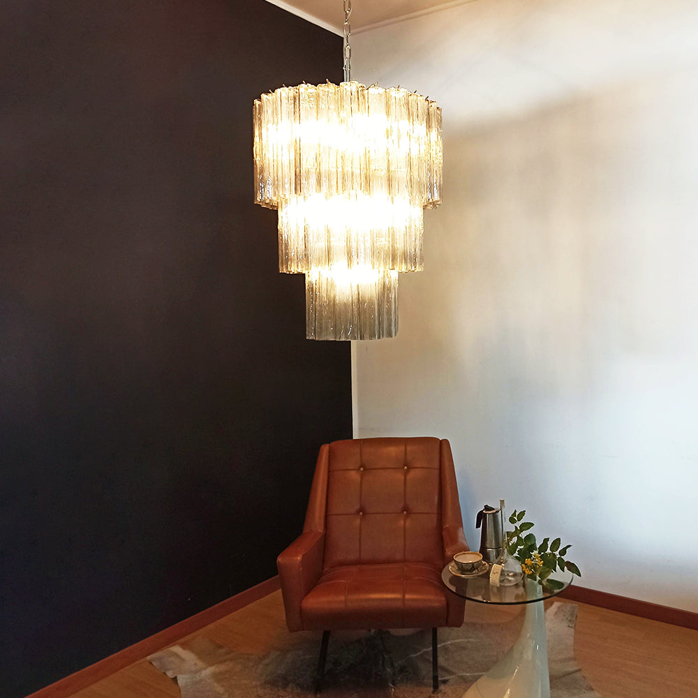 Fantastic Murano Tubes Chandelier with clear glass hanging in a dark corner with a leather chair