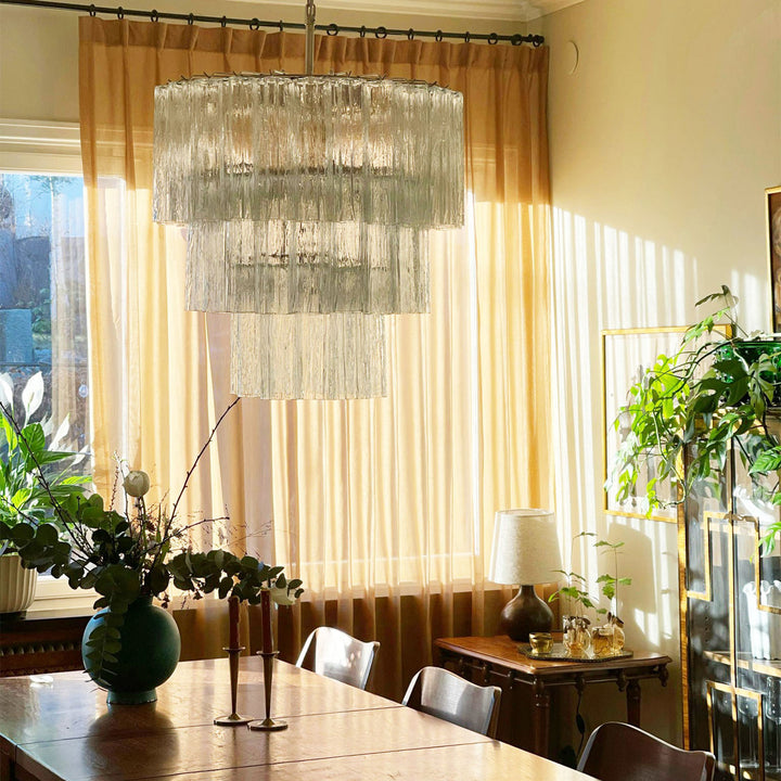 Fantastic Murano Tubes Chandelier with clear glass above a dining table with sheer curtains