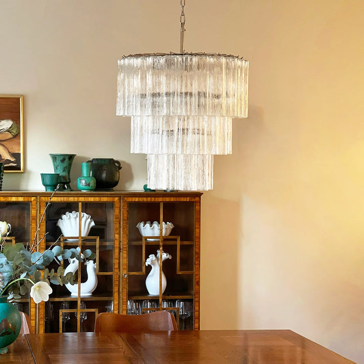 Fantastic Murano Tubes Chandelier with clear glass above a wooden dining table with china cabinet
