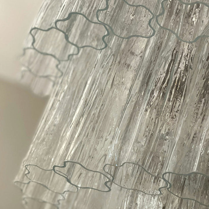 Close-up of rippled texture and star-shaped edges on clear Murano glass tubes