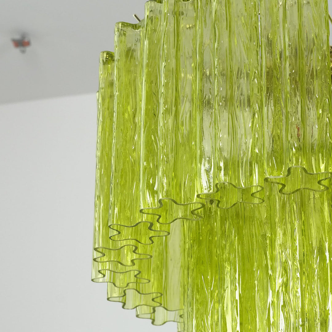 Close-up of layered lime green glass tubes showing light refraction through rippled texture