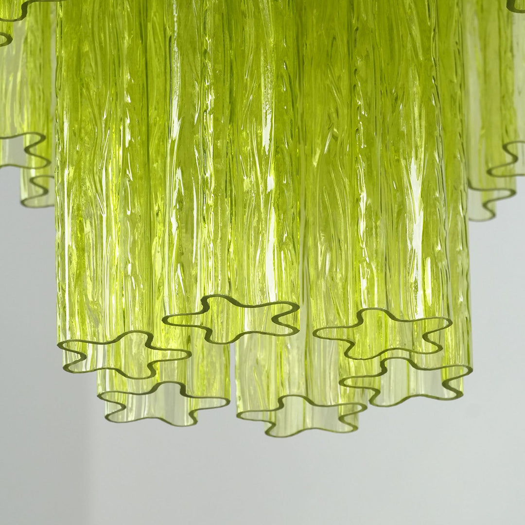 Close-up of layered lime green glass tubes with star-shaped wavy edges
