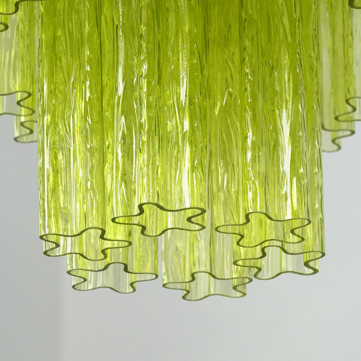 Close-up of layered lime green glass tubes with star-shaped wavy edges