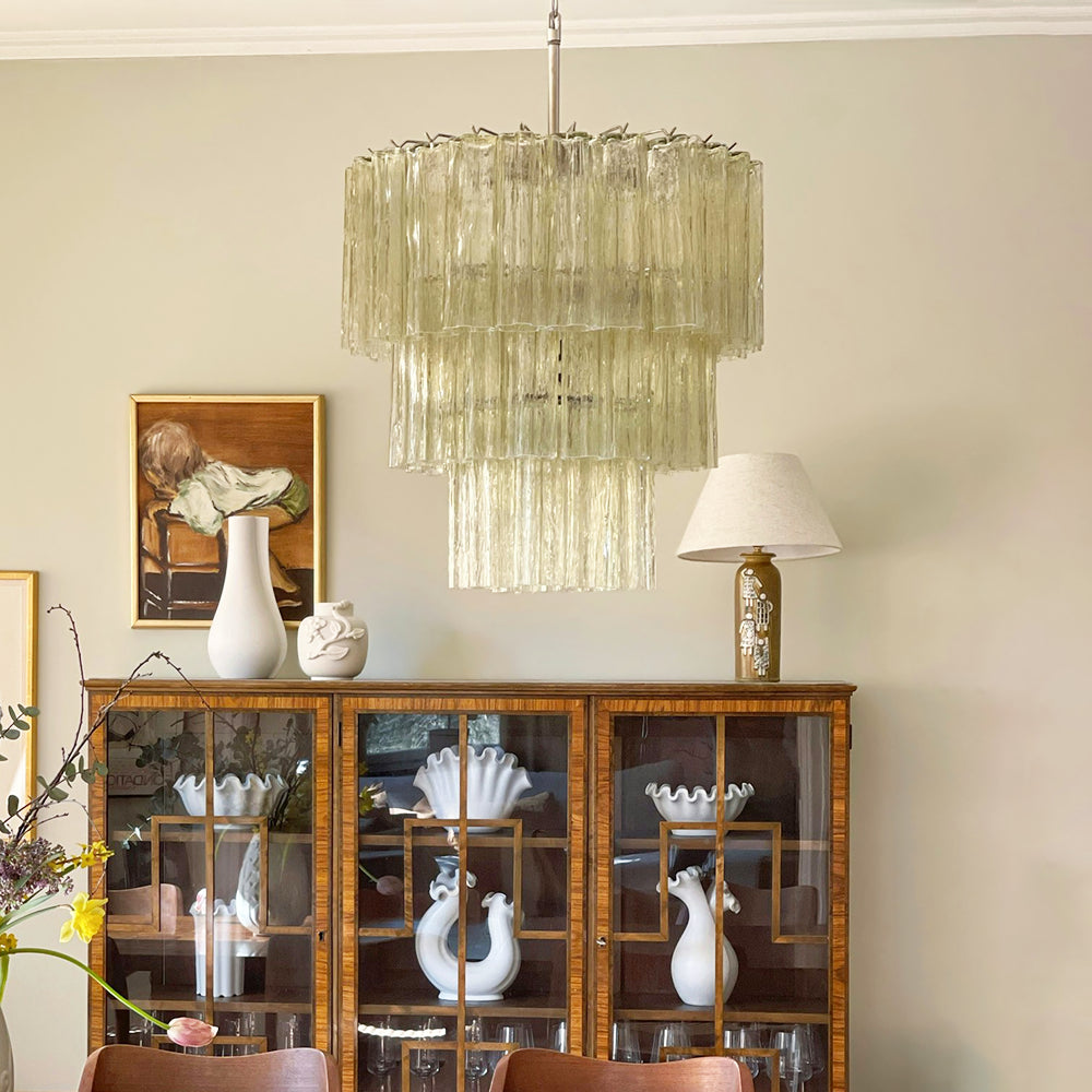 Fantastic Murano Tubes Chandelier with lime green glass above a wooden dining table with china cabinet