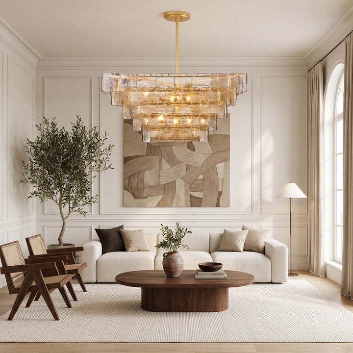 Glass panel chandelier in a neutral living room with a potted olive tree