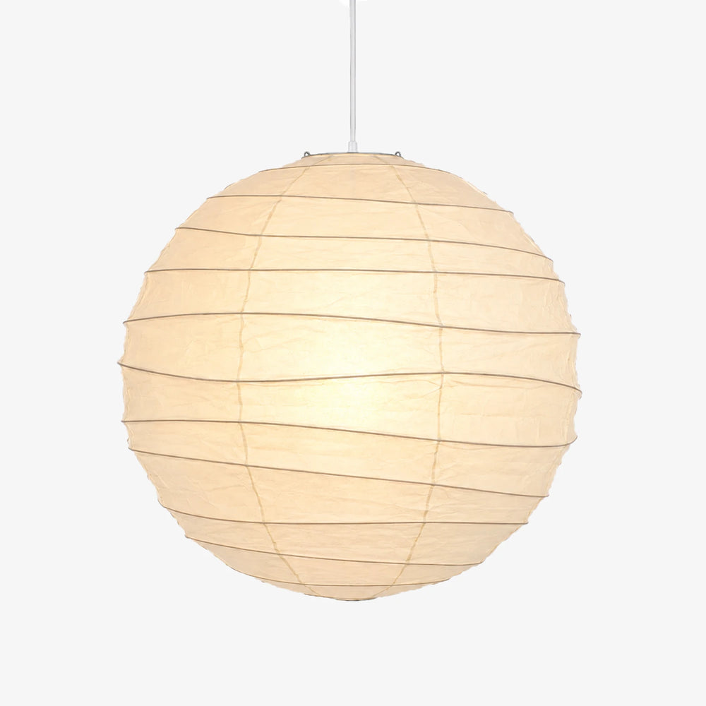 Paper ball light shown lit against a pale grey studio backdrop