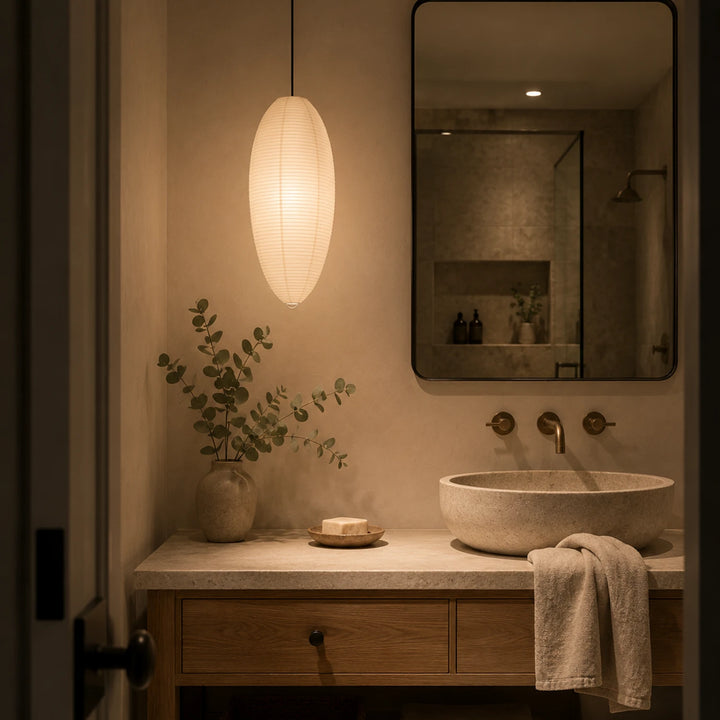 Oval paper pendant glowing above a desk in a quiet home office corner