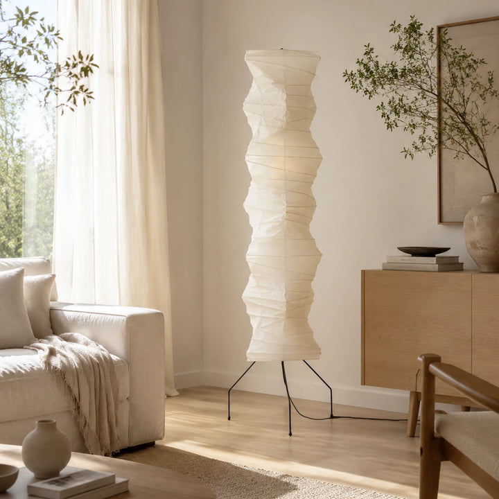 Japandi paper floor lamp glowing softly beside sheer curtains and a bouclé sofa