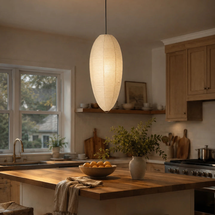 Oval paper pendant hanging above a wooden kitchen island in bright daylight