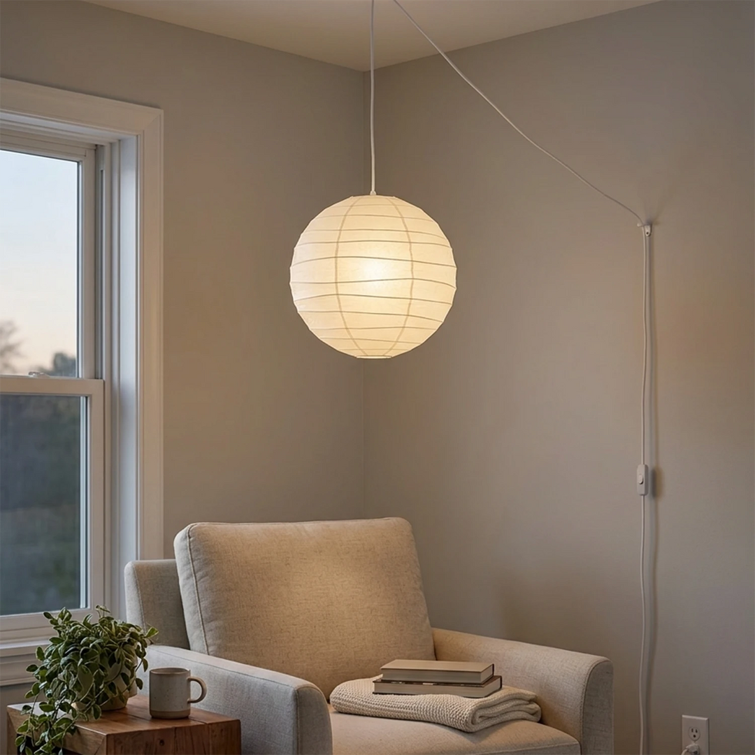 Minimalist paper pendant beside a window in a quiet seating corner