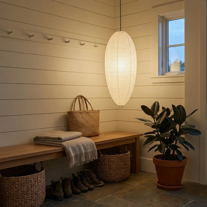 Oval paper pendant in a mudroom above a wooden bench and woven basket