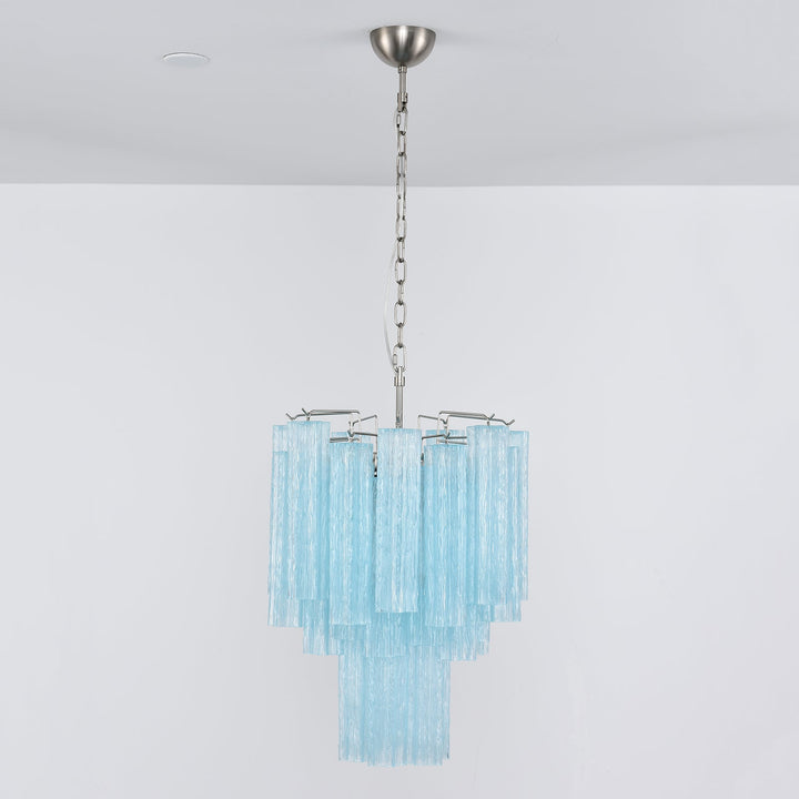 Corner view of Murano Glass Tube Chandelier with amber gold glass tubes on a white wall