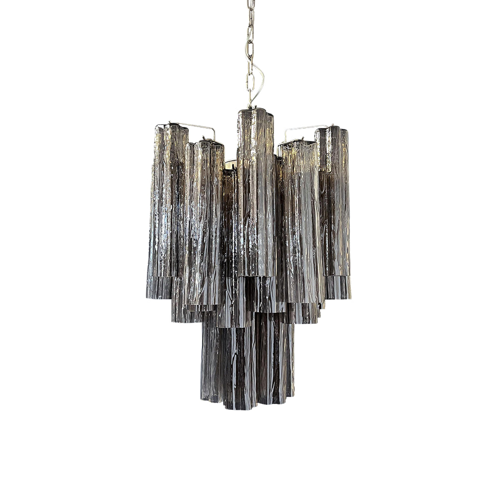 Full view of the lit Murano Glass Tube Chandelier with clear glass tubes on a white ceiling