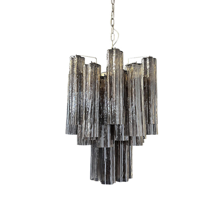 Full view of the lit Murano Glass Tube Chandelier with clear glass tubes on a white ceiling