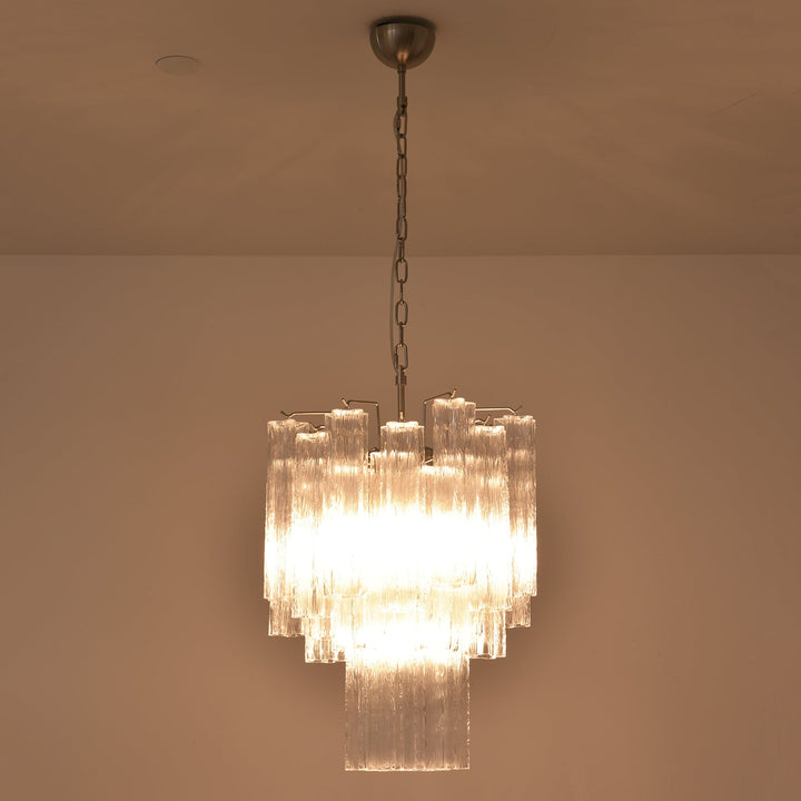Murano Glass Tube Chandelier with clear glass tubes lit with warm light on a white ceiling