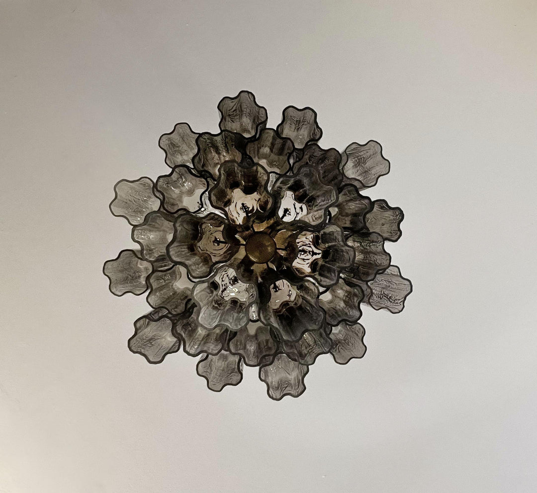 Close-up of the metal frame and pink glass tubes on the Murano chandelier
