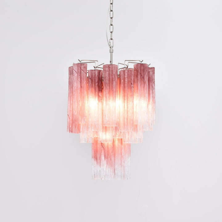 Murano Glass Tube Chandelier with pink gradient glass lit with warm light in a corner view