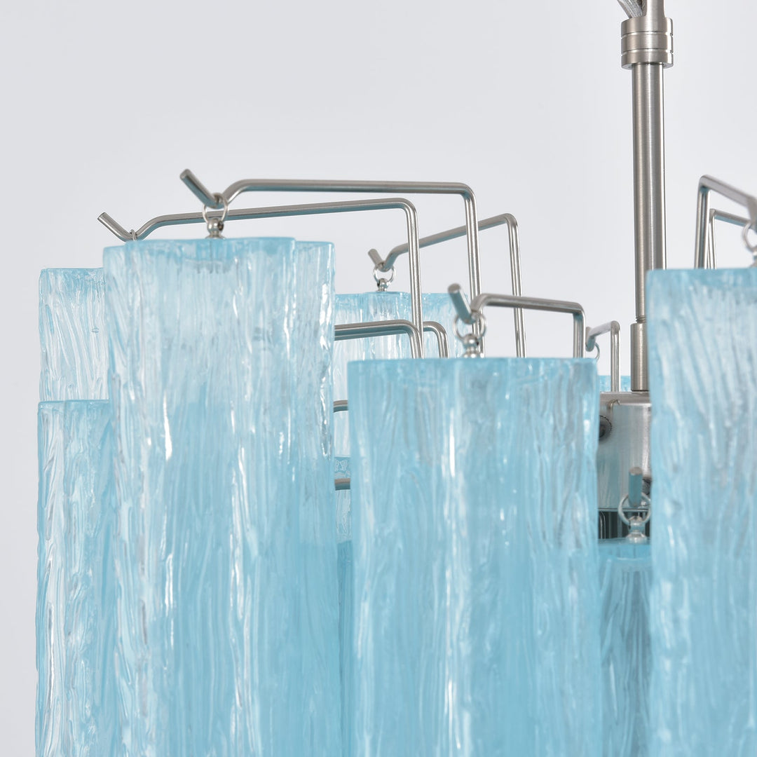 Close-up of the metal frame and turquoise glass tubes on the Murano chandelier