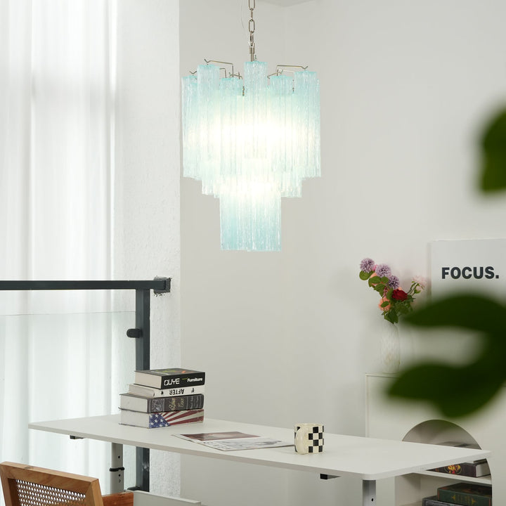 Murano Glass Tube Chandelier with turquoise glass above a desk with books and plants