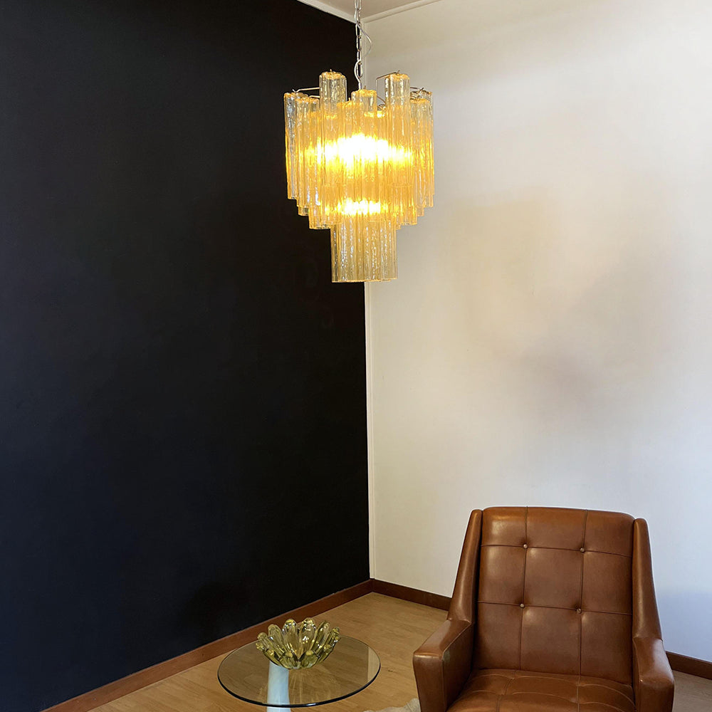 Murano Glass Tube Chandelier with warm yellow glass against a black accent wall