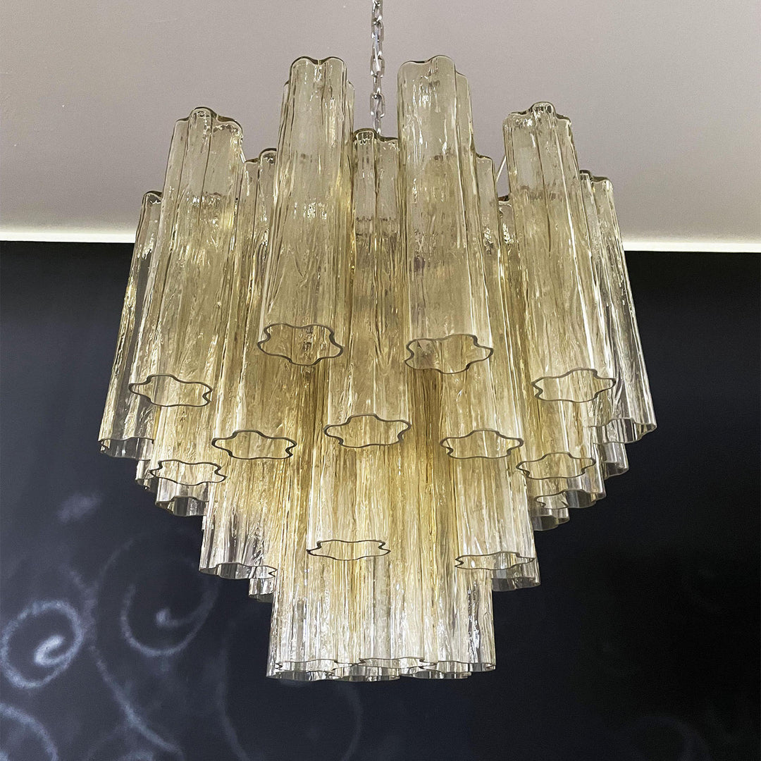 Murano Star Tube Chandelier with amber glass tubes in a dark room corner view