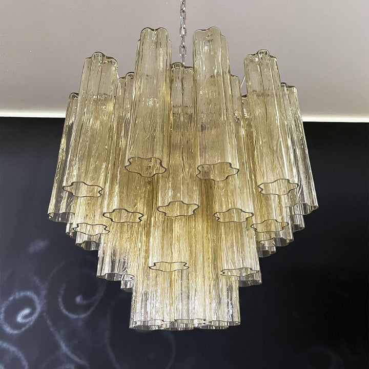 Murano Star Tube Chandelier with amber glass tubes in a dark room corner view