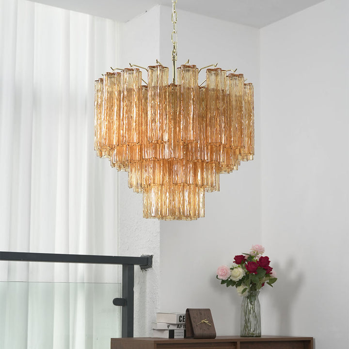 Murano Star Tube Chandelier with amber glass hanging above a dining table with floral decor