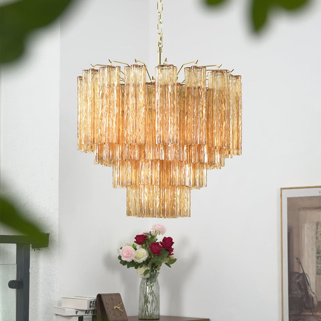 Murano Star Tube Chandelier with amber glass above a dining table with floral decor