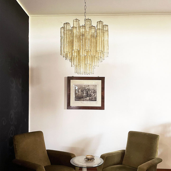 Murano Star Tube Chandelier with amber glass in a room with two green upholstered chairs and decor