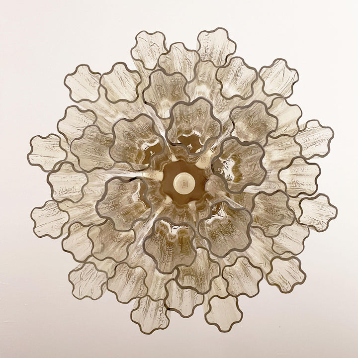 Top view of Murano Star Tube Chandelier with amber star-shaped glass elements on white background