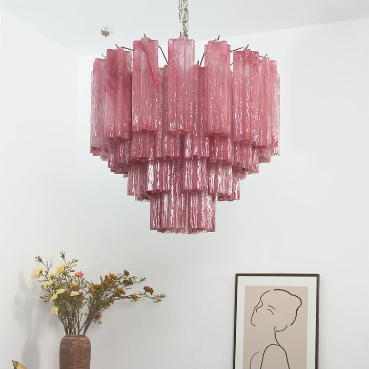 Murano Star Tube Chandelier with clear glass tubes against a black accent wall with a white chair