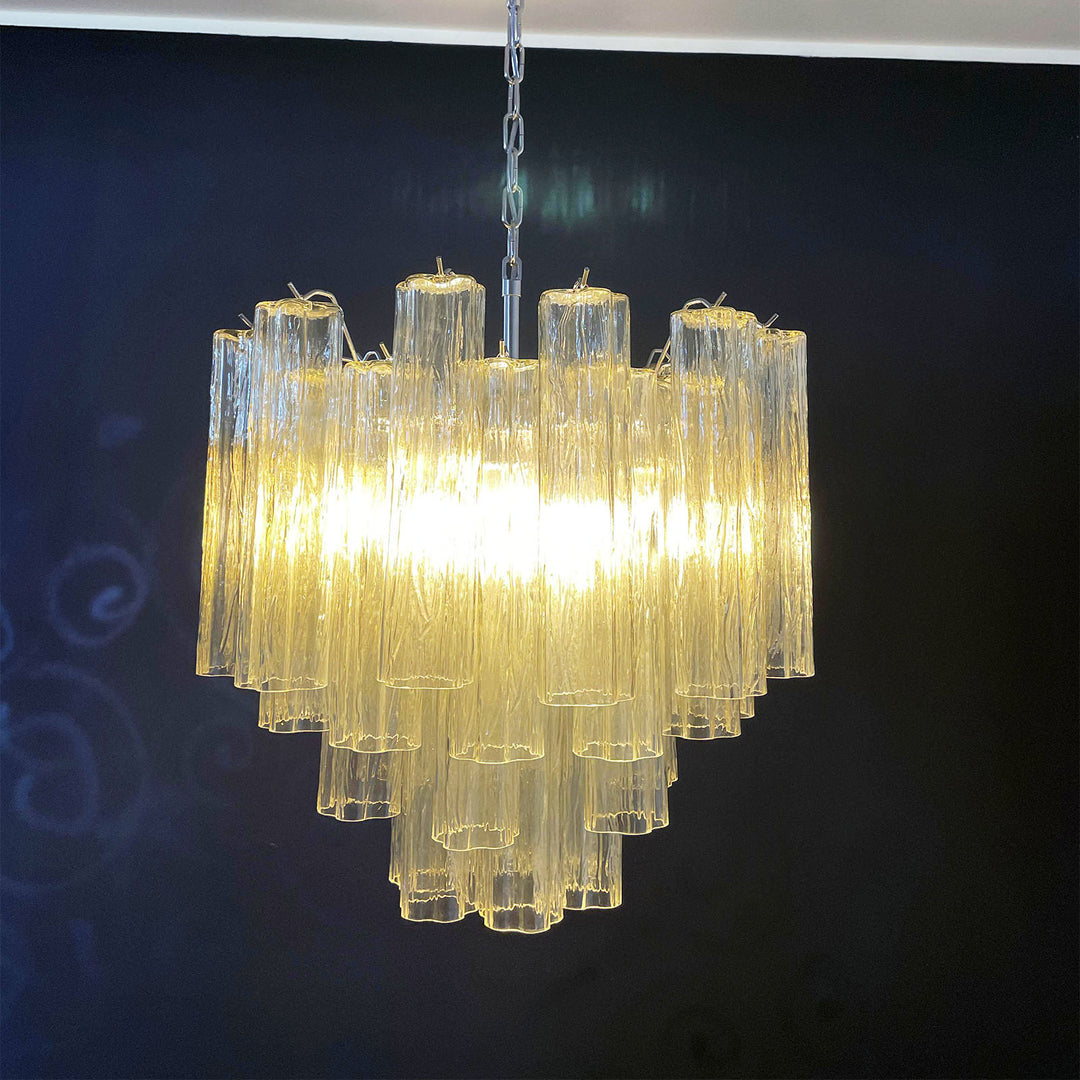 Lit Murano Star Tube Chandelier with clear glass tubes in a dark room corner view